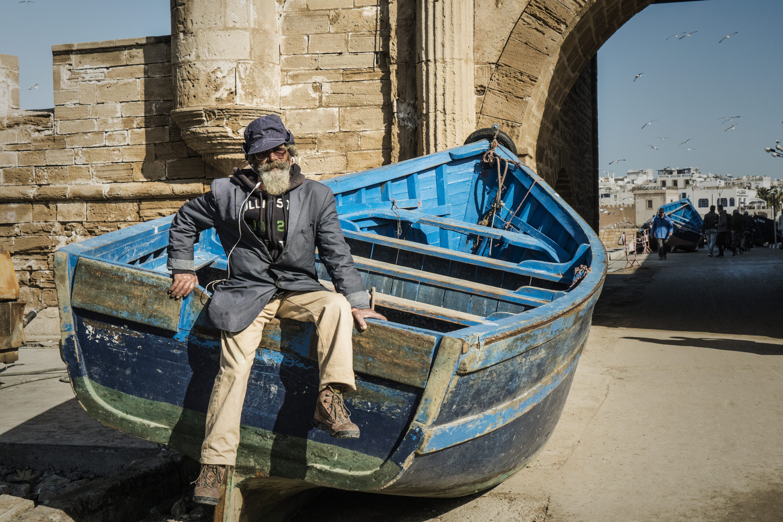 Essaouira, Morocco, 31 December 2017: Sailor with beard sitting on boat in harbor